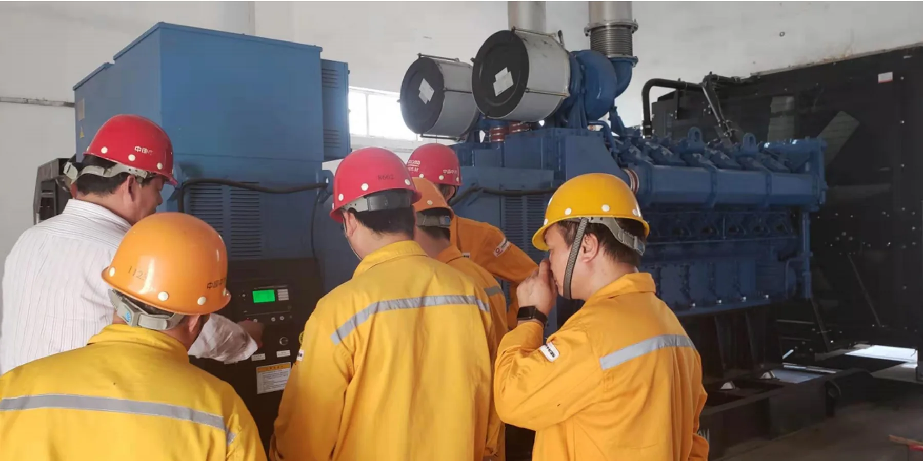 Technical team checking a diesel generator installation